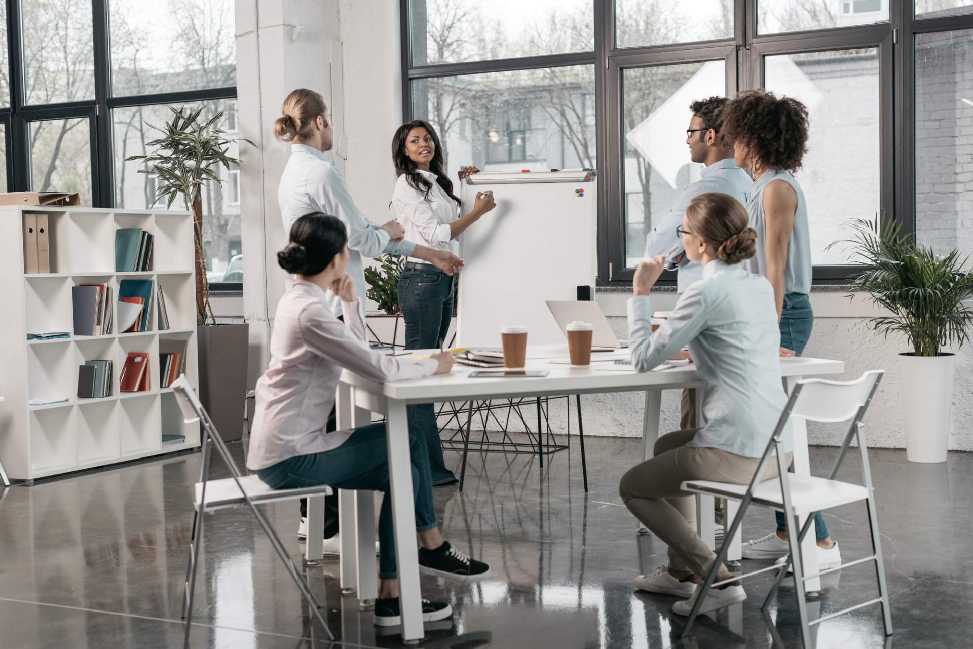 Workshop facilitation with a woman at a flip chart