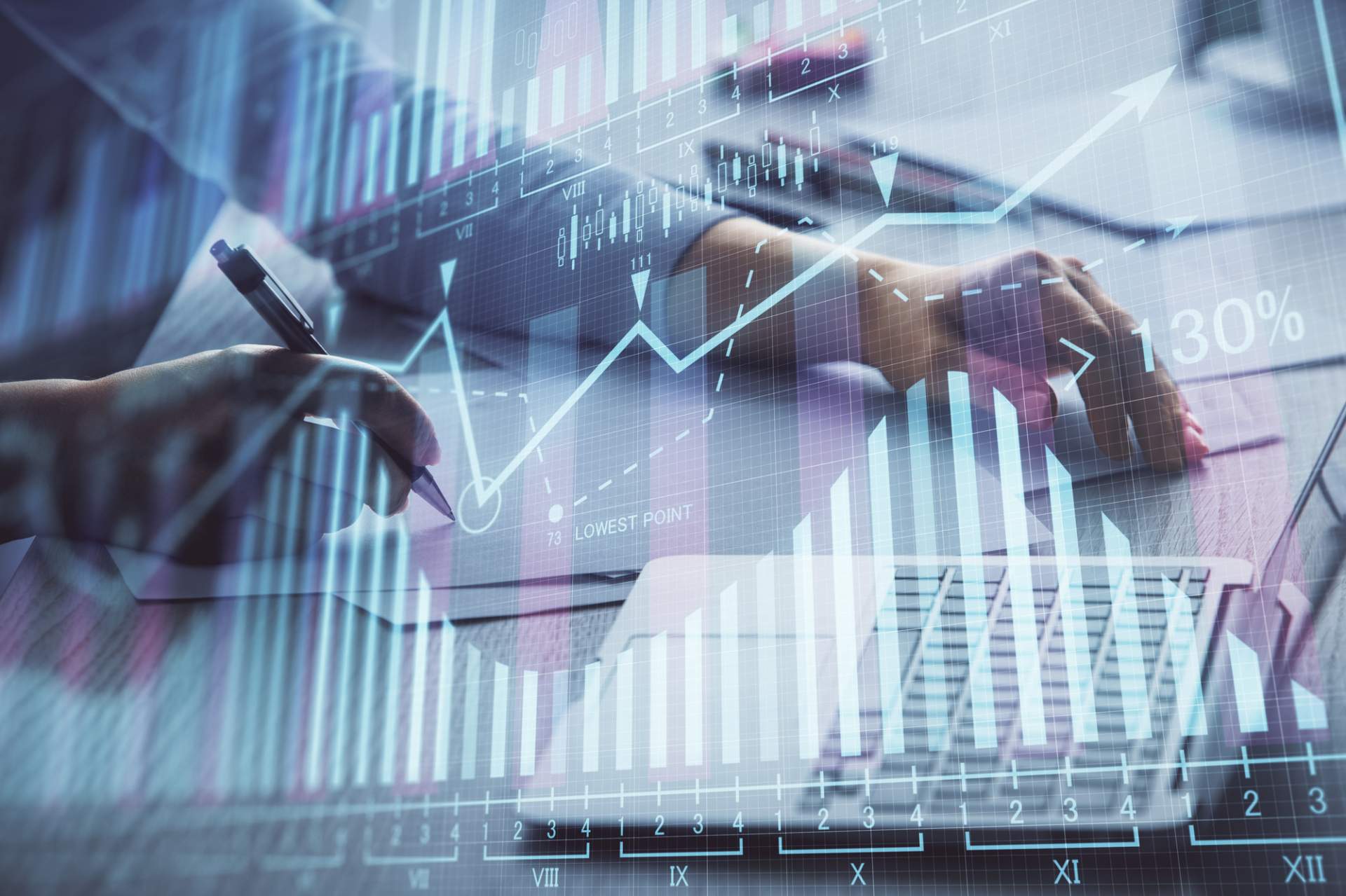 Man at a desk writing with an analysis chart overlaying the image